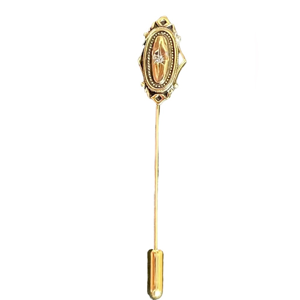 Vintage Avon gold tone stick pin with a crystal in the center